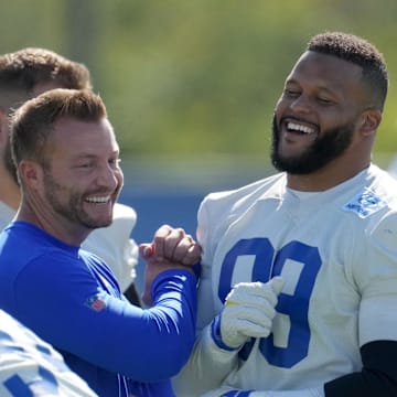 Jun 7, 2022; Thousand Oaks, California, USA; Los Angeles Rams defensive end Aaron Donald (99) and coach Sean McVay react during minicamp at Cal Lutheran University. Mandatory Credit: Kirby Lee-Imagn Images