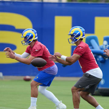 Jun 3, 2025; Woodland Hills, CA, USA; Los Angeles Rams quarterbacks Matthew Stafford (left), Jimmy Garoppolo (center) and Stetson Bennett take the snap during organized team activities at Rams Practice Facility. Mandatory Credit: Kirby Lee-Imagn Images