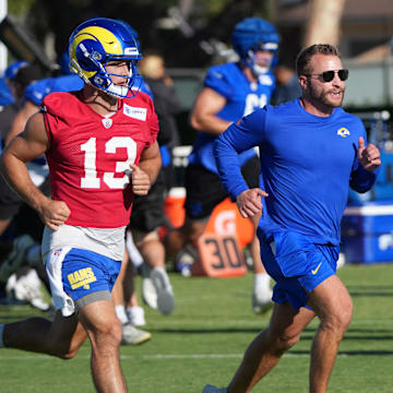 Jul 23, 2025; Los Angeles, CA, USA; Los Angeles Rams coach Sean McVay runs with quarterback Stetson Bennett (13) during training camp at Loyola Marymount University. Mandatory Credit: Kirby Lee-Imagn Images