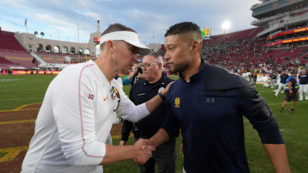 Southern California Trojans head coach Lincoln Riley and Notre Dame Fighting Irish head coach Marcus Freeman shake hands afte