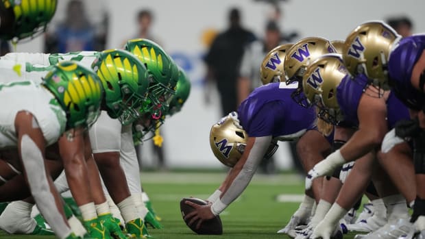 Helmets of the Oregon Ducks and Washington Huskies at the line of scrimmage during the Pac-12 Championship game in the first 