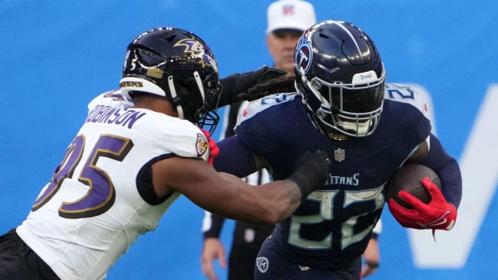 Oct 15, 2023; London, United Kingdom; Tennessee Titans running back Derrick Henry (22) carries the ball against Baltimore Ravens linebacker Tavius Robinson (95) in the second half during an NFL International Series game at Tottenham Hotspur Stadium. Mandatory Credit: Kirby Lee-USA TODAY Sports