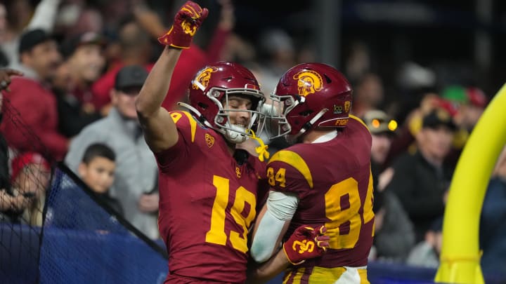 Dec 27, 2023; San Diego, CA, USA; Southern California Trojans wide receiver Duce Robinson (19) and tight end Carson Tabaracci (84) celebrate after a touchdown against the Louisville Cardinals in the Holiday Bowl at Petco Park. Mandatory Credit: Kirby Lee-USA TODAY Sports