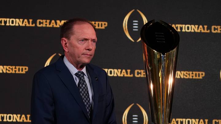 Jan 9, 2024; Houston, TX, USA; College Football Playoff senior director of communications Brett Daniels poses with CFP National Championship trophy at press conference at JW Marriot Houston by the Galleria. Mandatory Credit: Kirby Lee-USA TODAY Sports