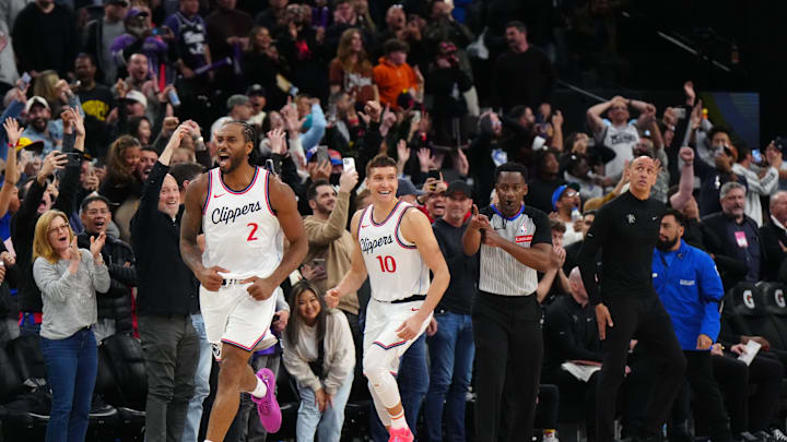 Mar 9, 2025; Inglewood, California, USA; LA Clippers forward Kawhi Leonard (2) celebrates with guard Bogdan Bogdanovic (10) after making the game-winning shot in overtime as Sacramento Kings coach Doug Christie watches at the Intuit Dome. Mandatory Credit: Kirby Lee-Imagn Images