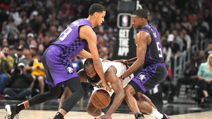 Feb 25, 2024; Los Angeles, California, USA; LA Clippers guard James Harden (1) is defended by Sacramento Kings guard De'Aaron Fox (5) and forward Keegan Murray (13) in the second half at Crypto.com Arena. Mandatory Credit: Kirby Lee-USA TODAY Sports