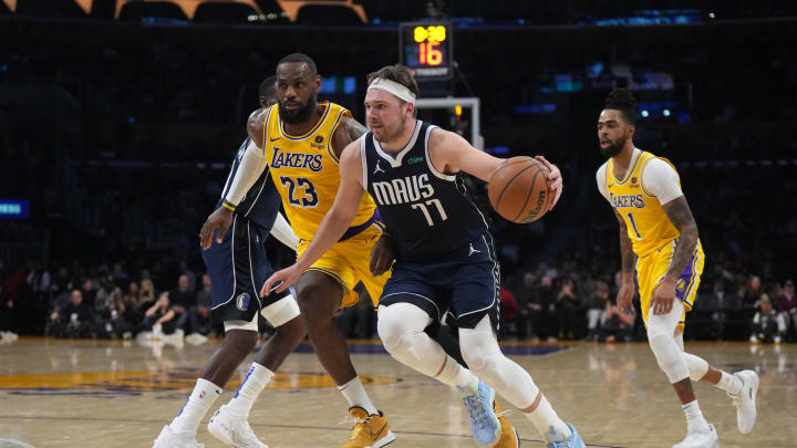 Jan 17, 2024; Los Angeles, California, USA; Dallas Mavericks guard Luka Doncic (77) dribbles the ball against Los Angeles Lakers forward LeBron James (23) in the first half at Crypto.com Arena. Mandatory Credit: Kirby Lee-USA TODAY Sports