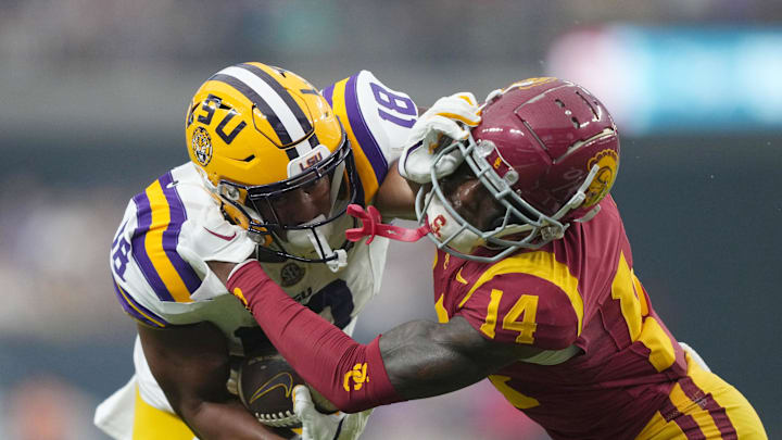 Sep 1, 2024; Paradise, Nevada, USA; LSU Tigers running back Josh Williams (18) carries the ball against Southern California Trojans cornerback Jacobe Covington (14) in the first half at Allegiant Stadium. Mandatory Credit: Kirby Lee-Imagn Images