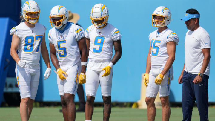 Jun 13, 2024; Costa Mesa, CA, USA; Los Angeles Chargers wide receivers coach Sanjay Lal (right) talks with wide receiver Simi Fehoko (87), Joshua Palmer (5), DJ Chark (9) and Ladd McConkey (15) during minicamp at the Hoag Performance Center. Mandatory Credit: Kirby Lee-USA TODAY Sports