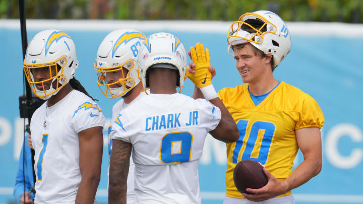 Jun 13, 2024; Costa Mesa, CA, USA; Los Angeles Chargers quarterback Justin Herbert (10) interacts with wide receivers Quentin Johnston (1), Simi Fehoko (87) and D.J. Clark (9) during minicamp at the Hoag Performance Center.  Mandatory Credit: Kirby Lee-USA TODAY Sports
