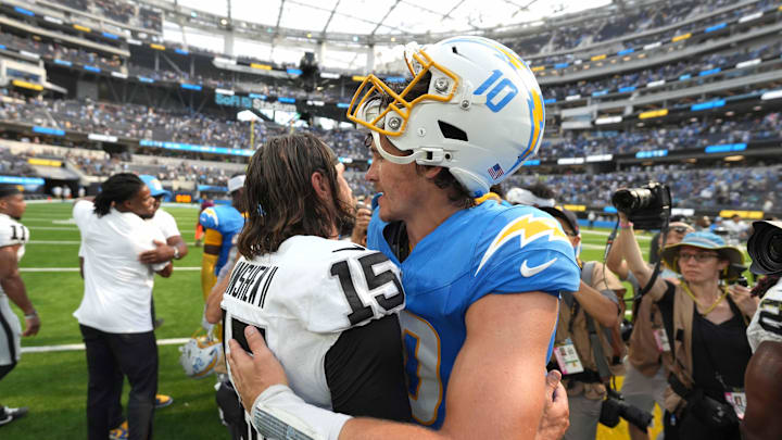 Sep 8, 2024; Inglewood, California, USA; Las Vegas Raiders quarterback Gardner Minshew (15) and Los Angeles Chargers quarterback Justin Herbert (10) embrace after the game at SoFi Stadium. Mandatory Credit: Kirby Lee-Imagn Images