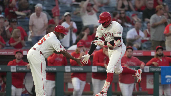 Los Angeles Angels right fielder Jo Adell (7) is congratulated by third base coach Eric Young Sr. (85)  after hitting a home run in the third inning against the Seattle Mariners at Angel Stadium on Aug 31.