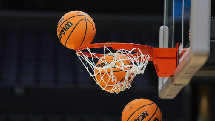 Mar 27, 2024; Los Angeles, CA, USA; Wilson official Evo NXT game basketballs with March Madness and Elite 8 and Sweet logo approaches the rim and net at Crypto.com Arena. Mandatory Credit: Kirby Lee-USA TODAY Sports