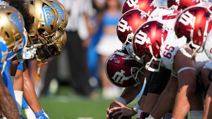 UCLA Bruins and Indiana Hoosiers helmets at the line of scrimmage during the game at Rose Bowl. Mandatory Credit: Kirby Lee-Imagn Images