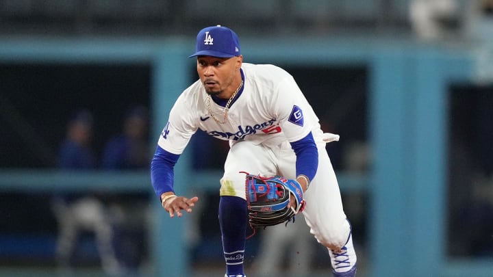 Jun 11, 2024; Los Angeles, California, USA; Los Angeles Dodgers shortstop Mookie Betts (50) fields the ball against the Texas Rangers at Dodger Stadium. Mandatory Credit: Kirby Lee-USA TODAY Sports