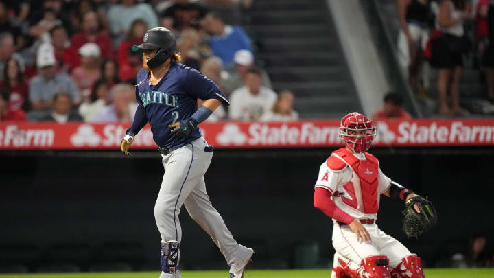 Seattle Mariners first baseman Justin Turner (2) crosses home plate after hitting a home run in the third inning as Los Angeles Angels catcher Logan O'Hoppe (14) watches at Angel Stadium on Aug 31.