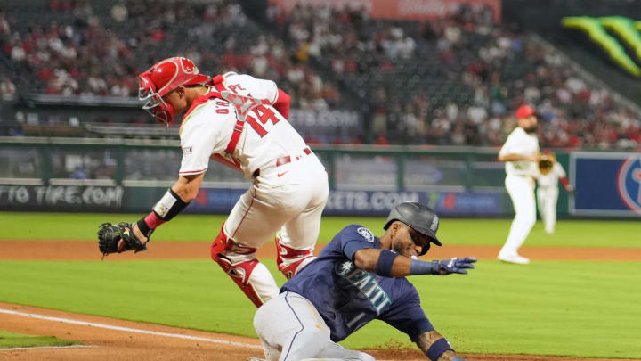 Seattle Mariners center fielder Victor Robles (10) slides into home plate  to beat  a throw to Los Angeles Angels catcher Logan O'Hoppe (14) to score in the fourth inning at Angel Stadium on Aug 31.