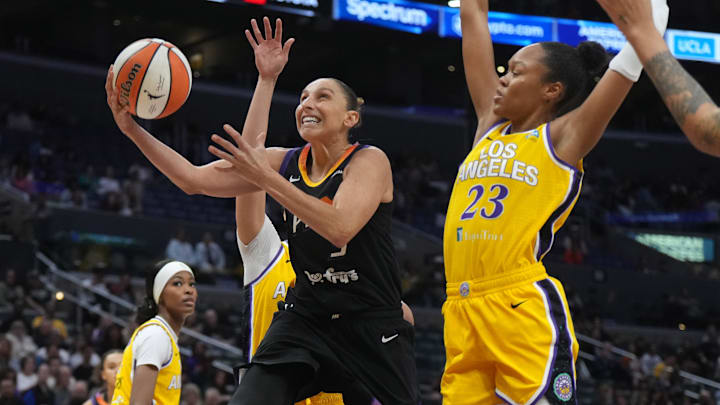 Sep 17, 2024; Los Angeles, California, USA; Phoenix Mercury guard Diana Taurasi (3) shoots the ball against LA Sparks forward Dearica Hamby (5) and forward Azura Stevens (23) in the first half at Crypto.com Arena. Mandatory Credit: Kirby Lee-Imagn Images