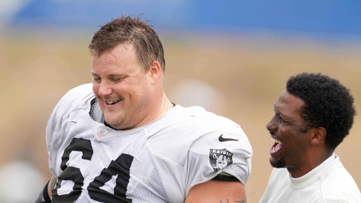 Aug 18, 2021; Thousand Oaks, CA, USA; Las Vegas Raiders  guard Richie Incognito (64) interacts with Los Angeles Rams vice president of communications Artis Twyman during a joint practice. Mandatory Credit: Kirby Lee-USA TODAY Sports