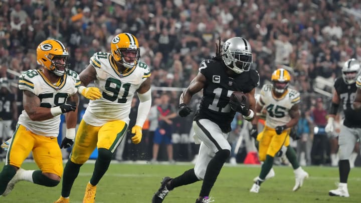 Oct 9, 2023; Paradise, Nevada, USA; Las Vegas Raiders wide receiver Davante Adams (17) is pursued by Green Bay Packers linebacker Preston Smith (91) and linebacker De'Vondre Campbell (59) in the second half at Allegiant Stadium. Mandatory Credit: Kirby Lee-USA TODAY Sports