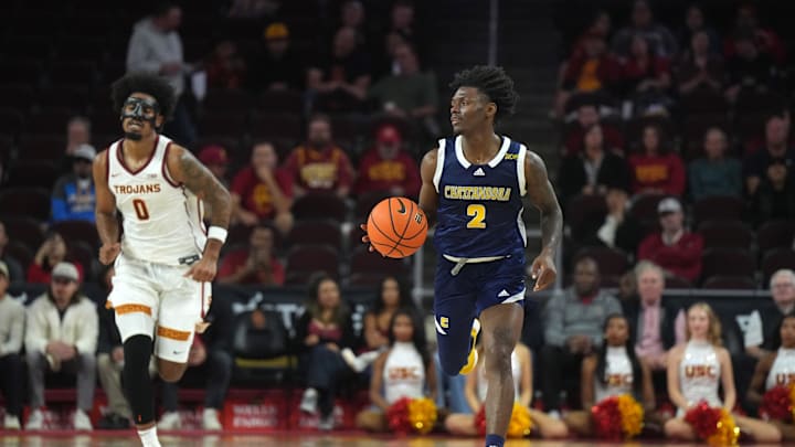 Nov 4, 2024; Los Angeles, California, USA; Chattanooga Mocs guard Trey Bonham (2) dribbles the ball against Southern California Trojans forward Saint Thomas (0) in the second half at Galen Center. Mandatory Credit: Kirby Lee-Imagn Images