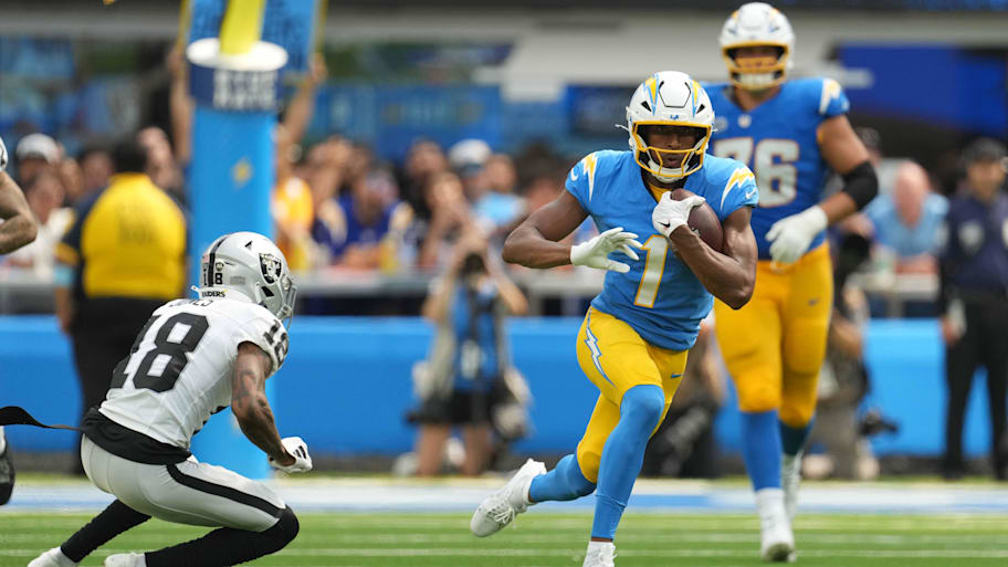 Sep 8, 2024; Inglewood, California, USA; Los Angeles Chargers wide receiver Quentin Johnston (1) carries the ball against Las Vegas Raiders cornerback Jack Jones (18) in the second half at SoFi Stadium. Mandatory Credit: Kirby Lee-Imagn Images | Kirby Lee-Imagn Images