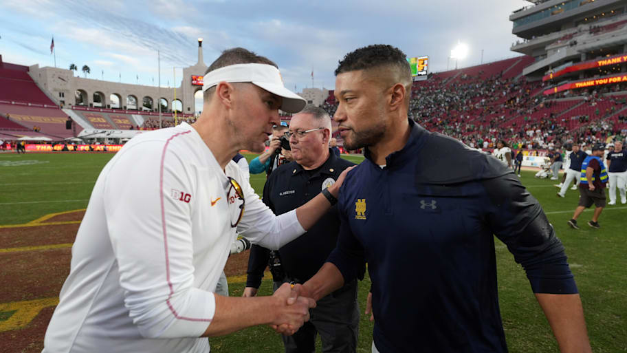 USC's Lincoln Riley and Notre Dame's Marcus Freeman shake hands after a 2024 game.