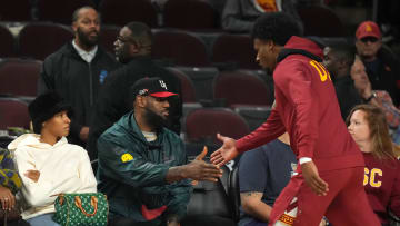 Jan 10, 2024; Los Angeles, California, USA; Southern California Trojans guard Bronny James (6) is greeted by father LeBron James during the game against the Washington State Cougars at Galen Center. Mandatory Credit: Kirby Lee-USA TODAY Sports