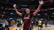 Kamilla Cardoso waves to the crowd at the Final Four.