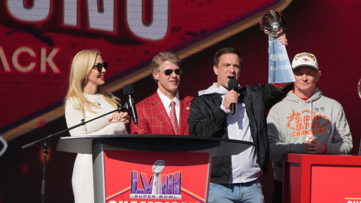 Feb 14, 2024; Kansas City, MO, USA; Kansas City Chiefs general manager Brett Veach speaks as owner Clark Hunt and wife Tavia Hunt and play-by-play announcer Mitch Holthus listen during the celebration of the Chiefs winning Super Bowl LVIII. Mandatory Credit: Kirby Lee-USA TODAY Sports