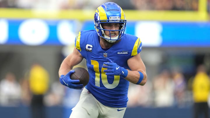 Los Angeles Rams wide receiver Cooper Kupp carries the ball against the Washington Commanders in the first half at SoFi Stadium.
