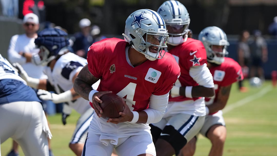 Dallas Cowboys quarterback Dak Prescott takes the snap at training camp at the River Ridge Fields. 