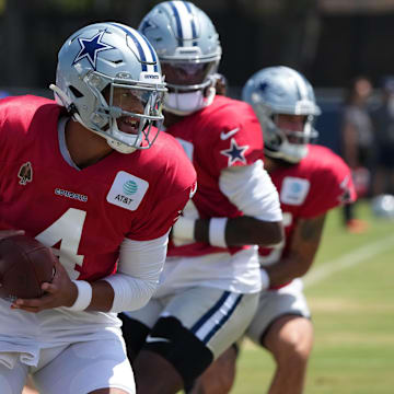 Dallas Cowboys quarterback Dak Prescott takes the snap at training camp at the River Ridge Fields. 