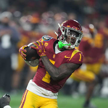 Dec 27, 2023; San Diego, CA, USA; Southern California Trojans wide receiver Zachariah Branch (1) catches the ball against Louisville Cardinals defensive lineman Stephen Herron (14) in the first half of the Holiday Bowl at Petco Park. Mandatory Credit: Kirby Lee-Imagn Images