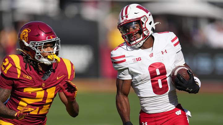 Sep 28, 2024; Los Angeles, California, USA; Wisconsin Badgers wide receiver Vinny Anthony II (8) carries the ball against Southern California Trojans cornerback Greedy Vance Jr. (21) in the second half at United Airlines Field at Los Angeles Memorial Coliseum. Mandatory Credit: Kirby Lee-Imagn Images