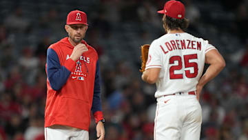 Apr 25, 2022; Anaheim, California, USA; Los Angeles Angels pitching coach Matt Wise (left) talks