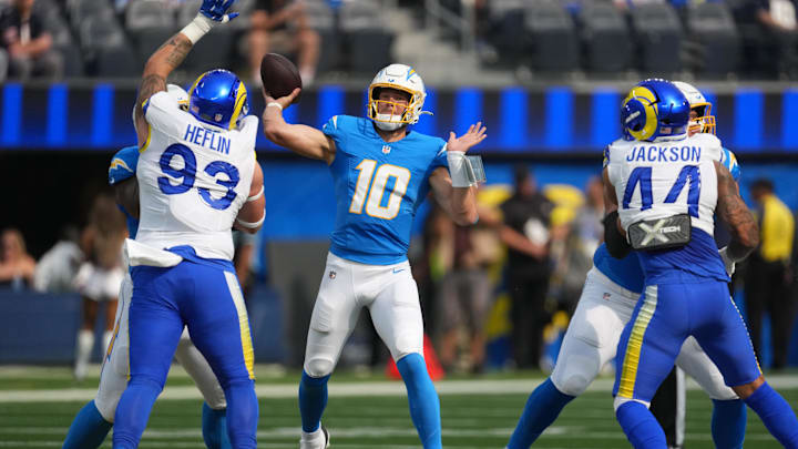 Aug 16, 2025; Inglewood, California, USA; Los Angeles Chargers quarterback Justin Herbert (10) throws the ball against the Los Angeles Rams in the first half at SoFi Stadium. Mandatory Credit: Kirby Lee-Imagn Images