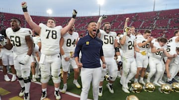 Nov 30, 2024; Los Angeles, California, USA; Notre Dame Fighting Irish head coach Marcus Freeman celebrates with players at the end of the game against the Southern California Trojans at United Airlines Field at Los Angeles Memorial Coliseum. Mandatory Credit: Kirby Lee-Imagn Images