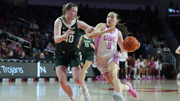 Feb 19, 2025; Los Angeles, California, USA; Southern California Trojans guard Kayleigh Heckel (9) dribbles the ball against Michigan State Spartans guard Julia Ayrault (40) in the first half at Galen Center. Mandatory Credit: Kirby Lee-Imagn Images