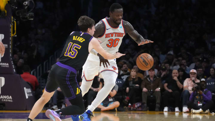 Dec 18, 2023; Los Angeles, California, USA; Los Angeles Lakers guard Austin Reaves (15) and New York Knicks forward Julius Randle (30) reach for the ball in the first half at Crypto.com Arena. Mandatory Credit: Kirby Lee-USA TODAY Sports