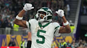 Oct 6, 2024; London, United Kingdom; New York Jets wide receiver Garrett Wilson (5) celebrates after scoring on a 1-yard touchdown reception against the New York Jets in the fourth quarter at Tottenham Hotspur Stadium. Mandatory Credit: Kirby Lee-Imagn Images