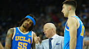 Mar 8, 2025; Los Angeles, California, USA; UCLA Bruins head coach Mick Cronin (center) talks with guard Skyy Clark (55) and guard Lazar Stefanovic (10) in the second half against the Southern California Trojans at Pauley Pavilion presented by Wescom. Mandatory Credit: Kirby Lee-Imagn Images