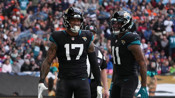 Oct 30, 2022; London, United Kingdom; Jacksonville Jaguars tight end Evan Engram (17) celebrates with wide receiver Marvin Jones Jr. (11) after scoring a touchdown in the first quarter against the Denver Broncos during an NFL International Series game at Wembley Stadium. Mandatory Credit: Kirby Lee-Imagn Images