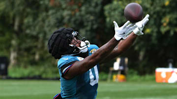 Oct 17, 2024; Watford, United Kingdom; Jacksonville Jaguars wide receiver Gabe Davis (0) catches the ball wearing a Guardian helmet cap during practice at The Grove. Mandatory Credit: Kirby Lee-Imagn Images