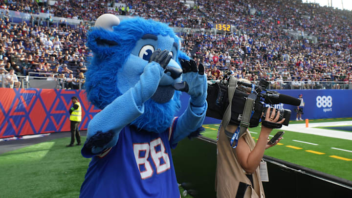 Buffalo Bills mascot Billy Buffalo interacts with WHAM TV camera person Jenna Cottrell during an NFL International Series game 