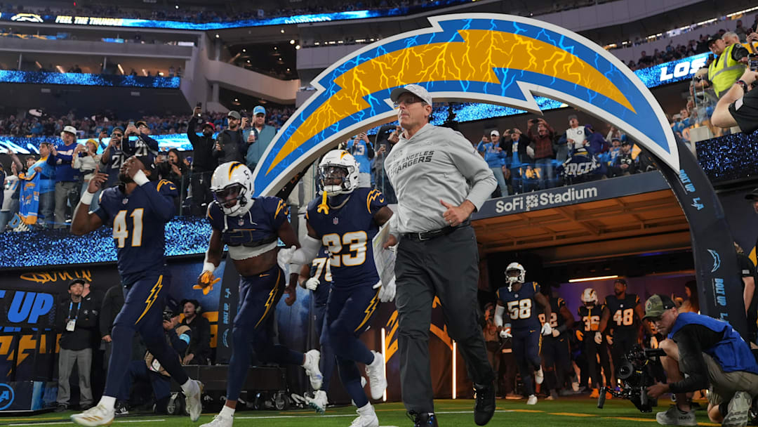 Nov 25, 2024; Inglewood, California, USA; Los Angeles Chargers coach Jim Harbaugh and cornerback Eli Apple (41) and wide receiver Joshua Palmer (5) and safety Tony Jefferson (23) enter the field before the game against the Baltimore Ravens at SoFi Stadium.