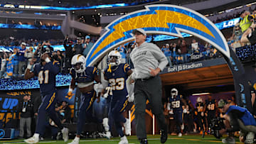 Nov 25, 2024; Inglewood, California, USA; Los Angeles Chargers coach Jim Harbaugh and cornerback Eli Apple (41) and wide receiver Joshua Palmer (5) and safety Tony Jefferson (23) enter the field before the game against the Baltimore Ravens at SoFi Stadium.