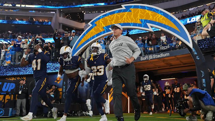 Nov 25, 2024; Inglewood, California, USA; Los Angeles Chargers coach Jim Harbaugh and cornerback Eli Apple (41) and wide receiver Joshua Palmer (5) and safety Tony Jefferson (23) enter the field before the game against the Baltimore Ravens at SoFi Stadium.