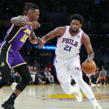 Mar 23, 2022; Los Angeles, California, USA; Philadelphia 76ers center Joel Embiid (21) is defended by Los Angeles Lakers center Dwight Howard (39) in the first half at Crypto.com Arena. Mandatory Credit: Kirby Lee-USA TODAY Sports