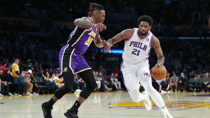 Mar 23, 2022; Los Angeles, California, USA; Philadelphia 76ers center Joel Embiid (21) is defended by Los Angeles Lakers center Dwight Howard (39) in the first half at Crypto.com Arena. Mandatory Credit: Kirby Lee-USA TODAY Sports